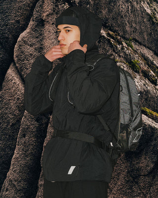 model-standing-in-front-of-rock-wall-wearing-urh-brand-hat-photo