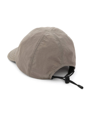 Baseball cap with short visor in outdoor setting