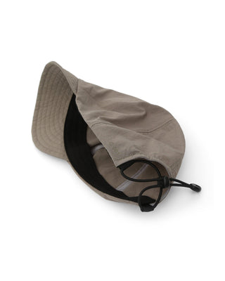 Foldable cap fitting into a travel bag