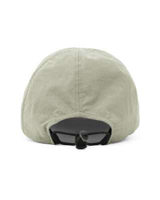 Foldable ball cap displayed on a backpack