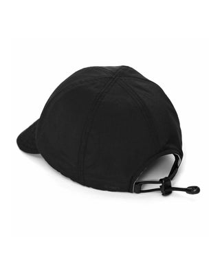 Baseball cap with short visor in outdoor setting