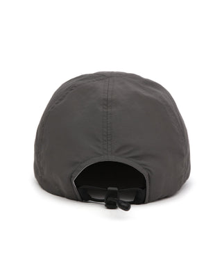 Baseball cap with short visor in outdoor setting