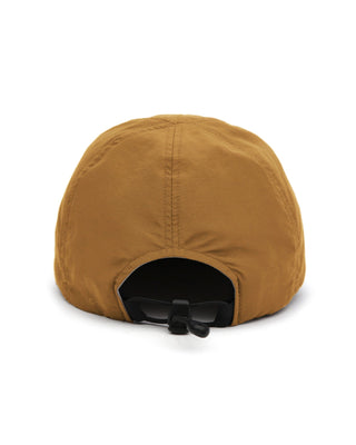 Foldable ball cap displayed on a backpack