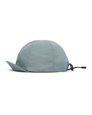 Baseball cap with short visor in outdoor setting