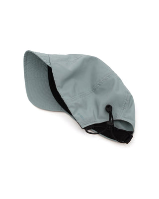 Foldable ball cap displayed on a backpack