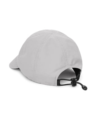 Baseball cap with short visor in outdoor setting