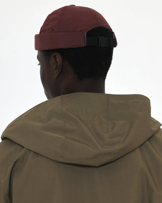 Adjustable brimless cap on a mountain peak