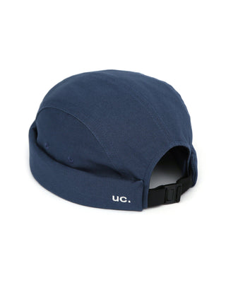 A watch cap worn by a cyclist on a forest trail.