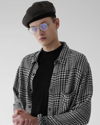 A newsboy cap on a mannequin in a fashion boutique.